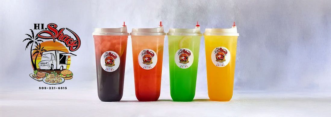Four cups of different colored drinks are lined up on a table.