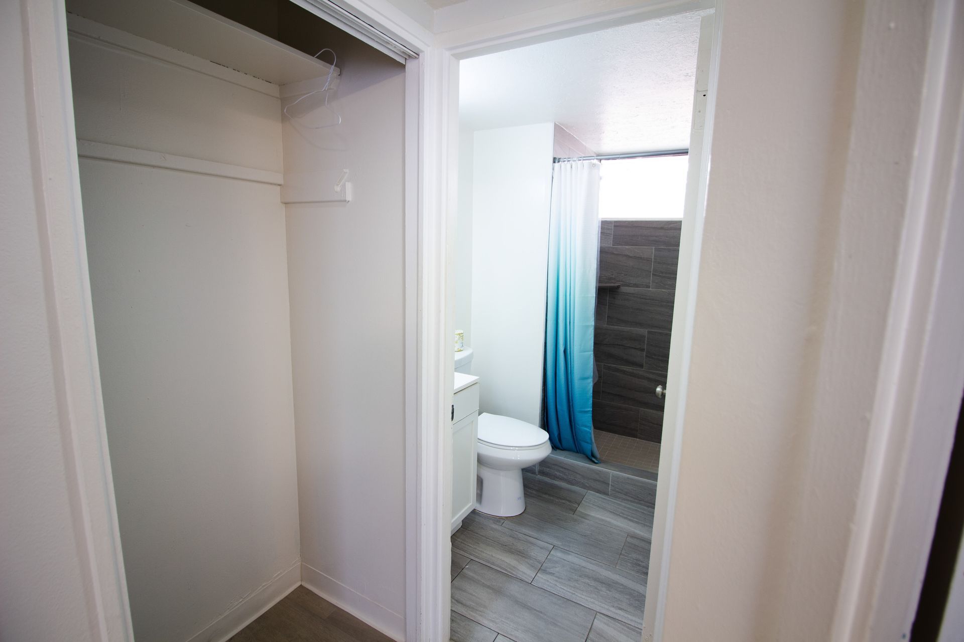 A bathroom with a toilet , sink and shower.