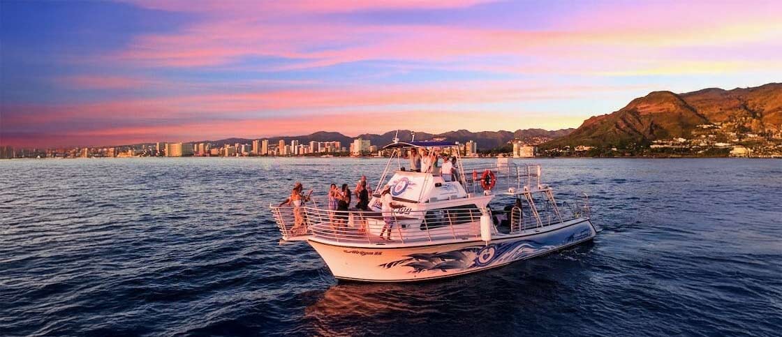 Waikiki sunset cocktail cruise party boat at golden hour