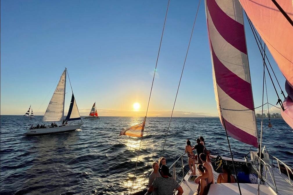 Waikiki sunset swim cruise catamaran at golden hour